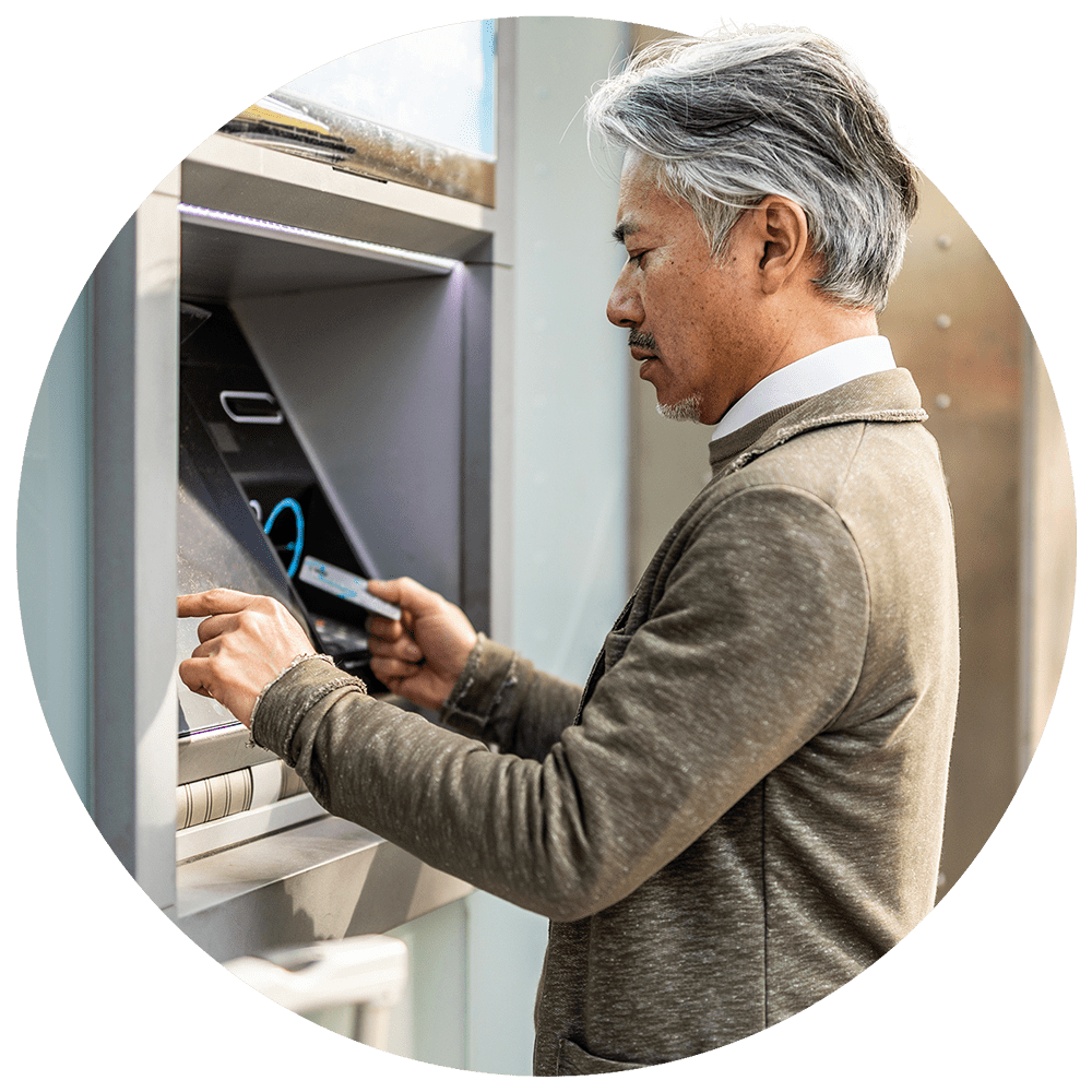 Man operating ATM